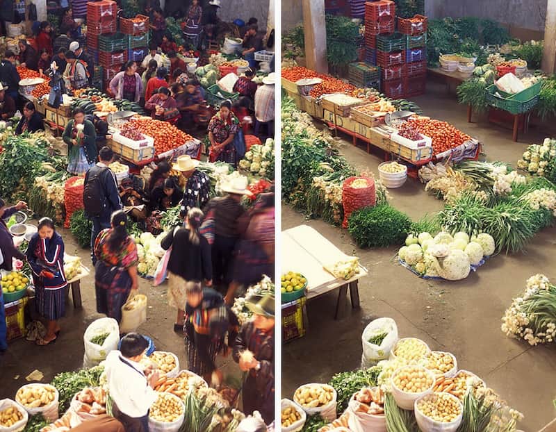 A bustling marketplace completely empty of people, showing only the produce stalls.
